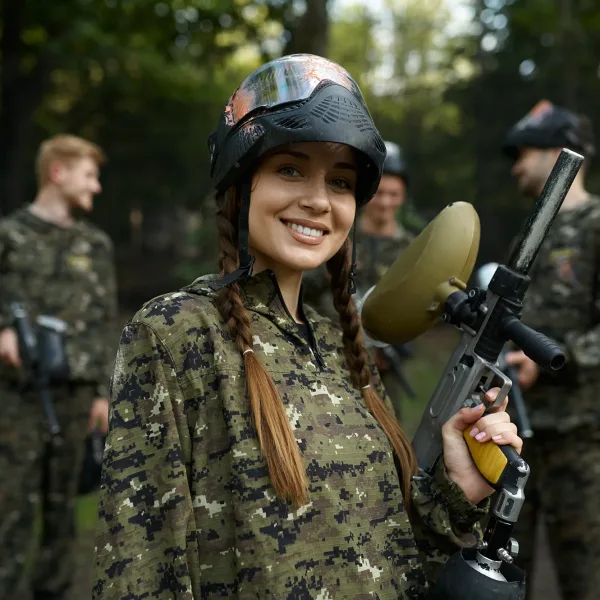 Soldiers in camouflage and masks playing paintball, war on playground in the forest. Extreme sport with pneumatic weapon and paint bullets or markers, military team game outdoors, combat tactics